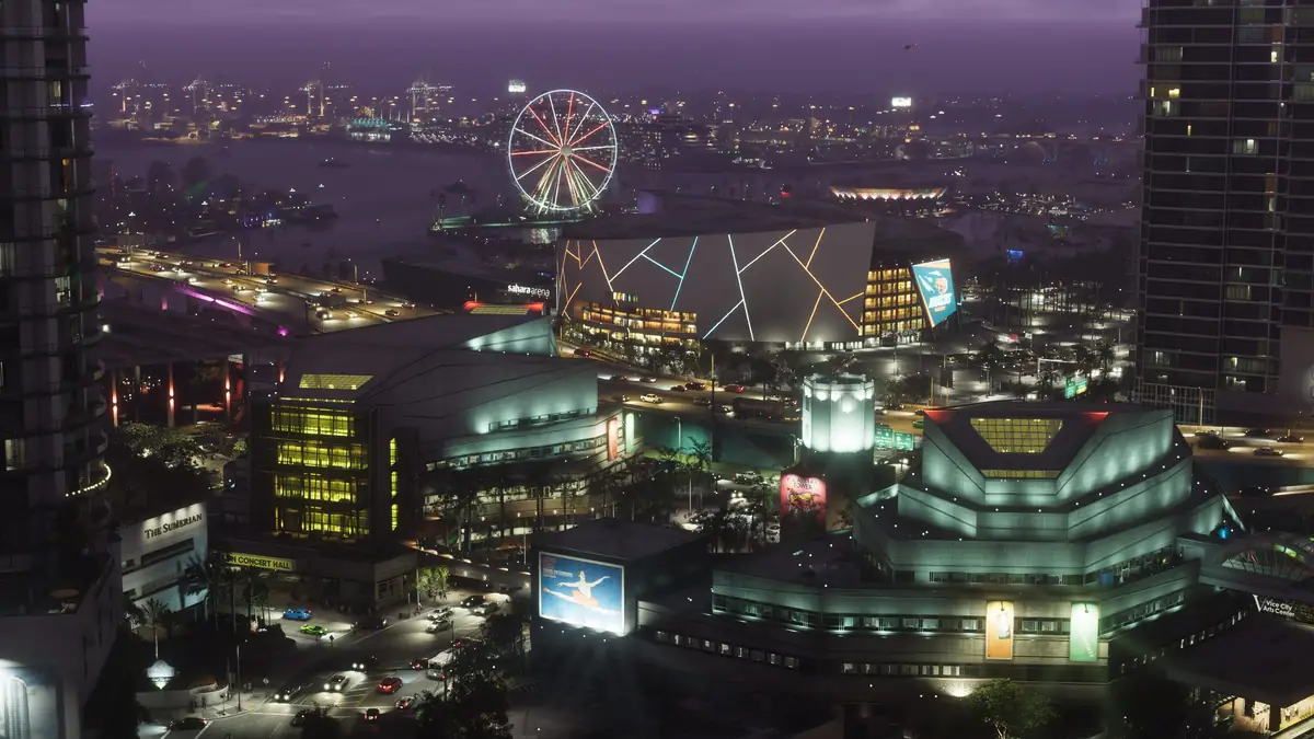 a Ferris wheel, an arena with a lit pattern on its roof and downtown towers beside the bay at night in a Rockstar Games image for GTA 6