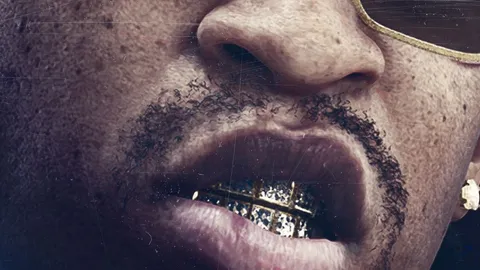 a close up of a man's mouth with diamond gold grills, a goatee and gold rimmed sunglasses in Rockstar Games artwork for the Dirty South Classics radio station in GTA 6