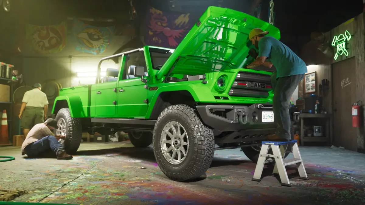 mechanics working on a green off road truck with its bonnet open inside a graffiti covered garage in a Rockstar Games image for GTA 6