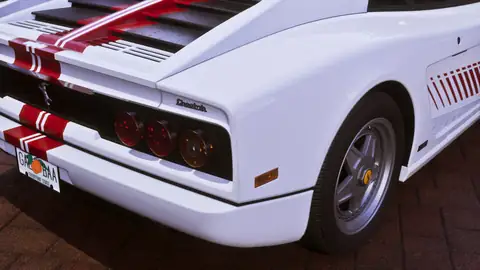the rear of a white Grotti Cheetah sports car with red stripes in a Rockstar Games image for GTA 6