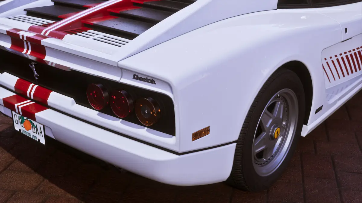 the rear of a white Grotti Cheetah sports car with red stripes in a Rockstar Games image for GTA 6