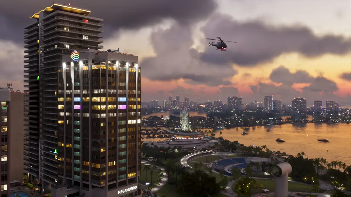 a Vice City tower and bay skyline at sunset with a helicopter overhead in an official GTA 6 screenshot