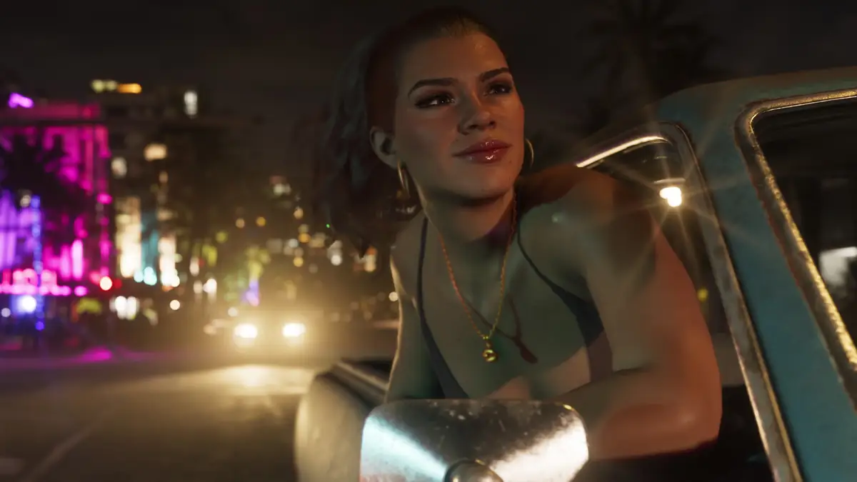 Lucia leaning out of a car window on a neon lit Vice City street at night in an official GTA 6 screenshot
