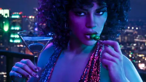 a woman with a cocktail against the Vice City skyline at night in a Rockstar Games image for GTA 6