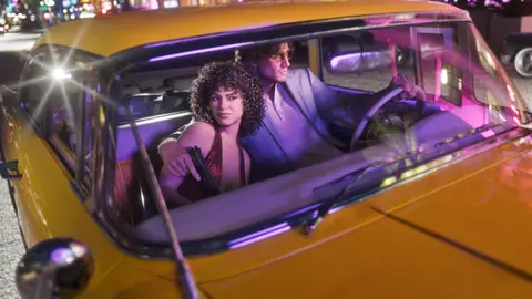 Jason and Lucia in a yellow car under pink neon night light in an official GTA 6 image
