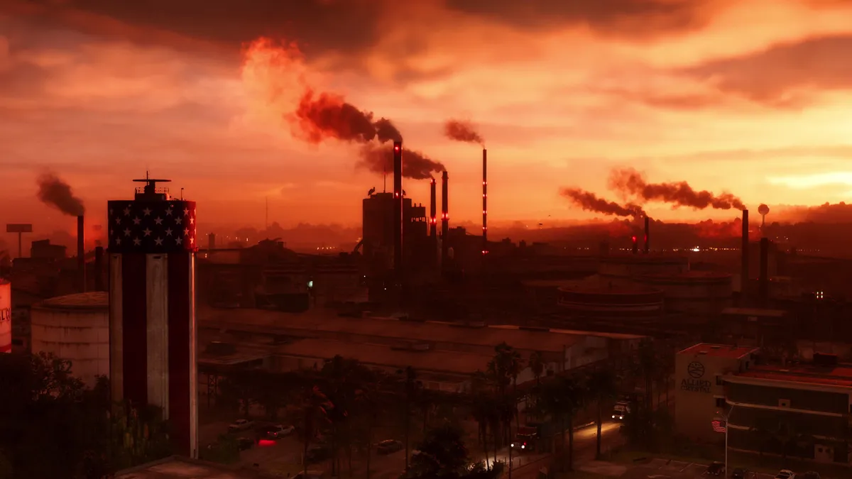 smoking factory chimneys under an orange sunset sky in an official GTA 6 screenshot