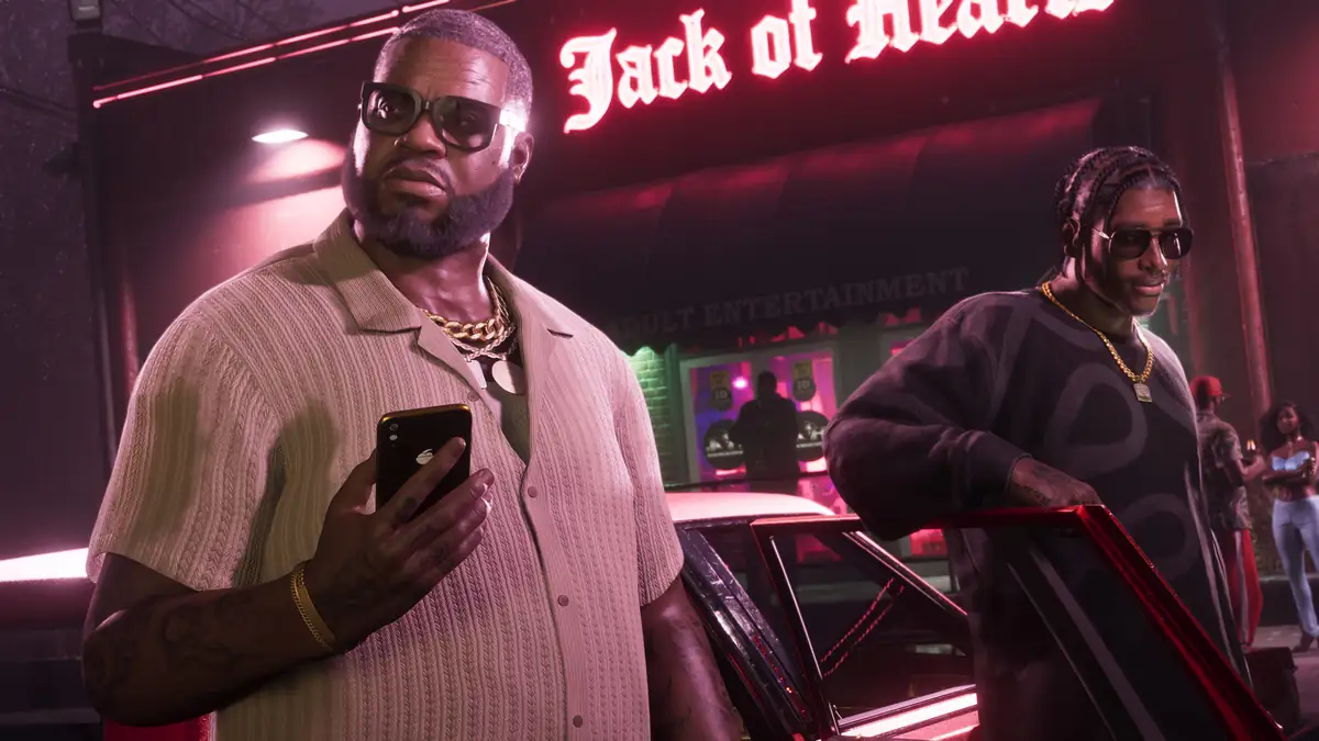 Boobie Ike holding a smartphone outside the neon lit Jack of Hearts club at night in a Rockstar Games image for GTA 6