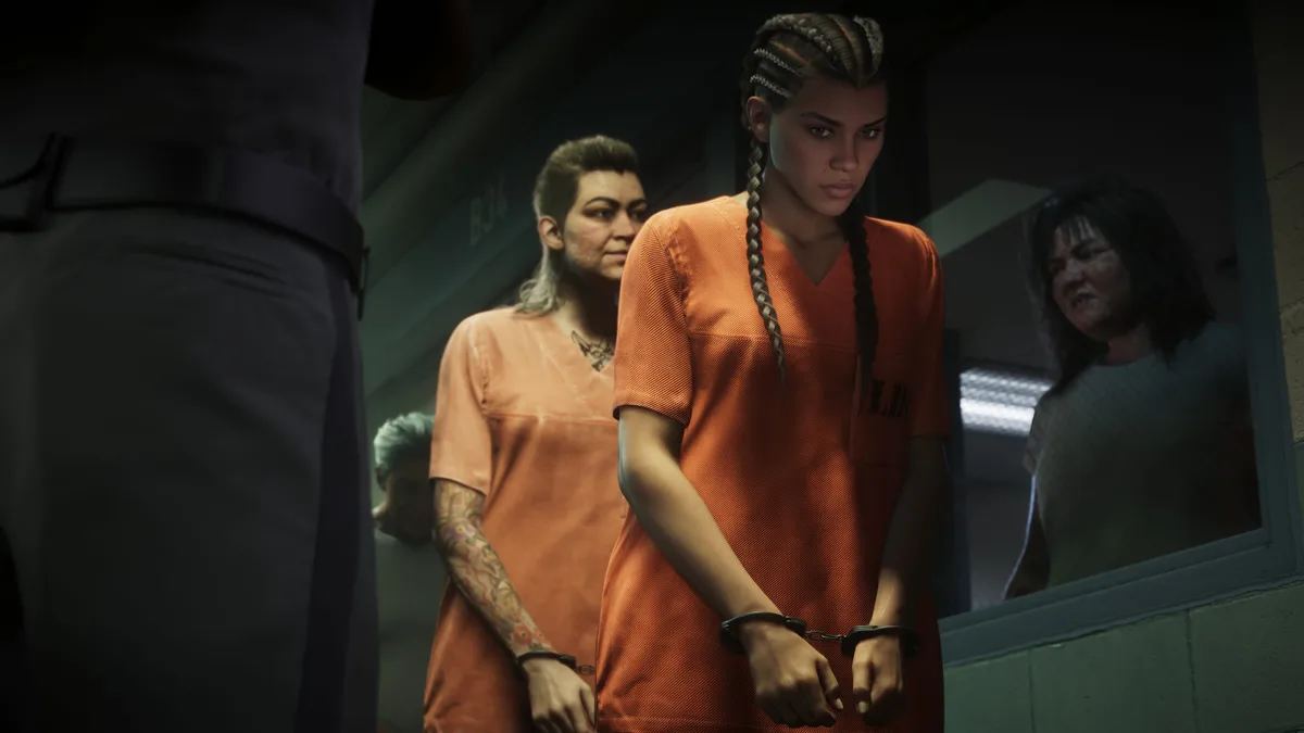 Lucia in an orange prison jumpsuit and handcuffs walking in line with other inmates in a Rockstar Games screenshot for GTA 6