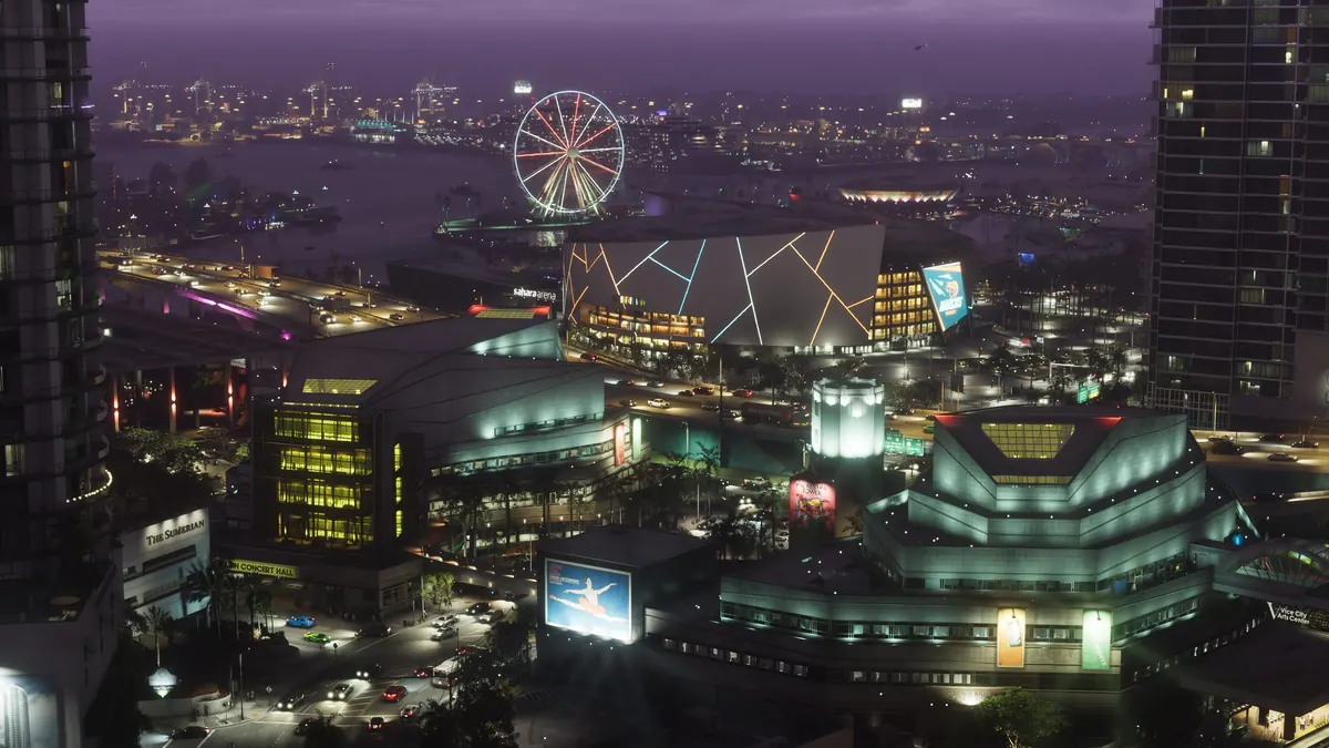 a Ferris wheel, an arena with a lit pattern on its roof and downtown towers beside the bay at night in a Rockstar Games image for GTA 6